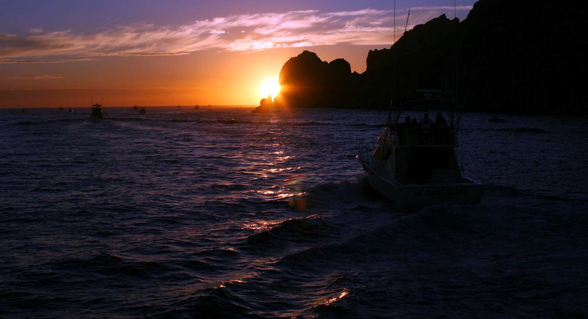 Boats leaving Cabo San Lucas marina in the early morning